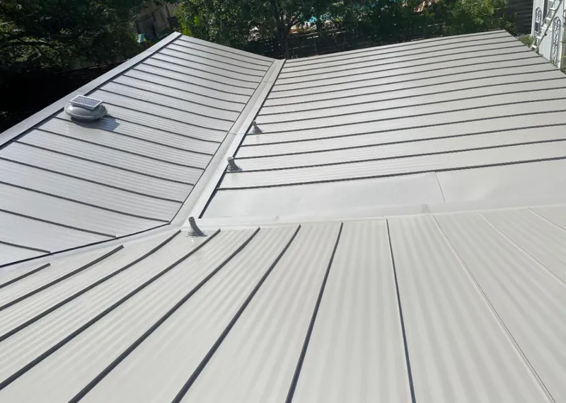 Solar attic fan installed on a metal roof for Roof Ventilation in Estes Park